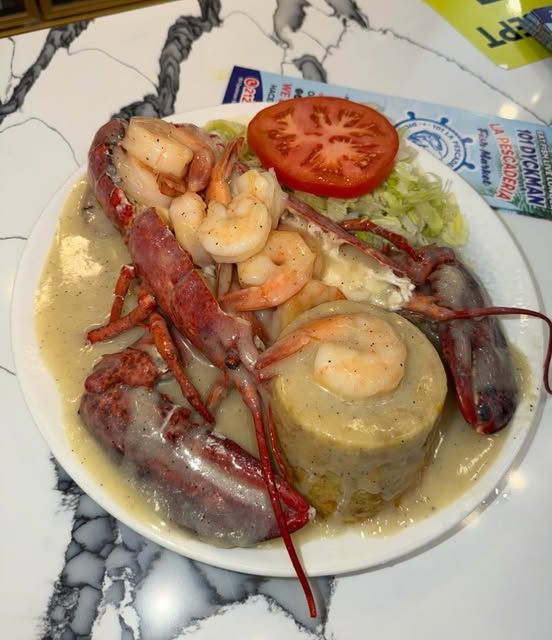 Lobster and shrimp in creamy garlic sauce over mofongo